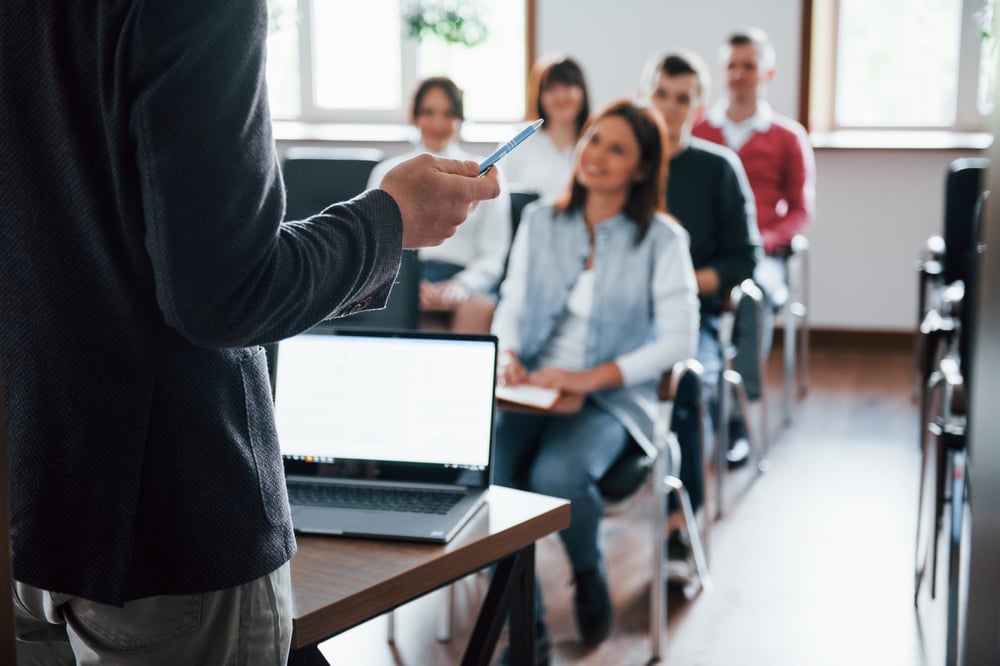 tout-le-monde-sourit-et-ecoute-groupe-de-personnes-lors-d-une-conference-d-affaires-dans-une-salle-de-classe-moderne-pendant-la-journee